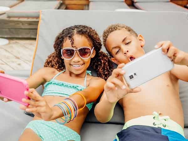 Kids taking selfies, at Sunny Isles Beach