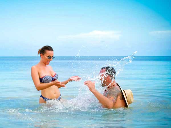 Couple playing in water at Sunny Isles Beach