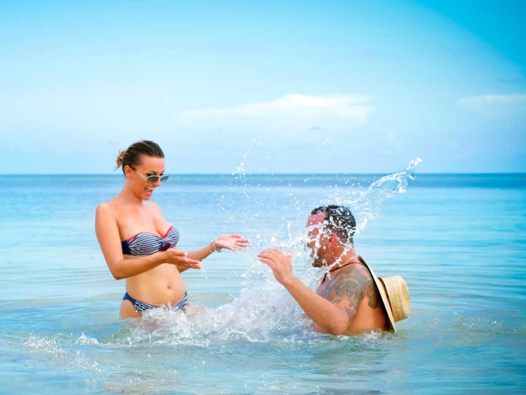Couple playing in the water, at Sunny Isles Beach