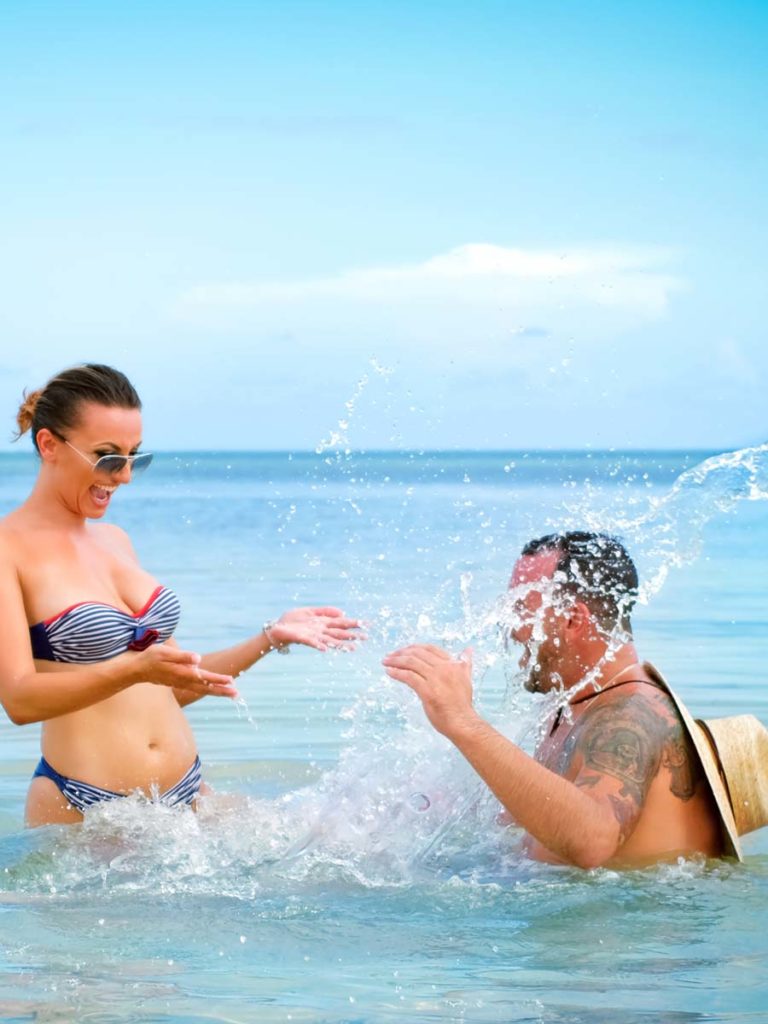 Couple playing in water at Sunny Isles Beach
