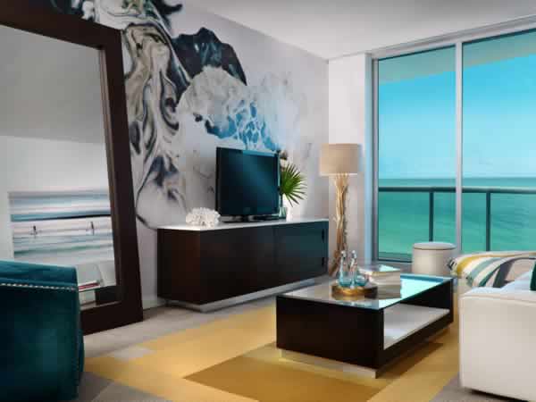 Sitting area in suite with view of the blue ocean.