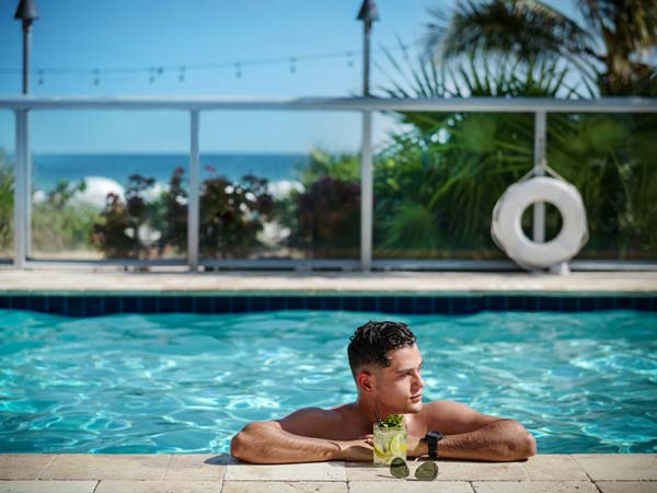 Guy With A Drink In The Pool