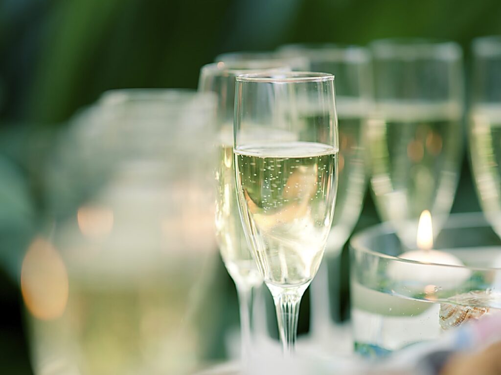Champagne flutes filled with sparkling wine at a celebration event at Sole Miami, A Noble House Resort on Sunny Isles Beach